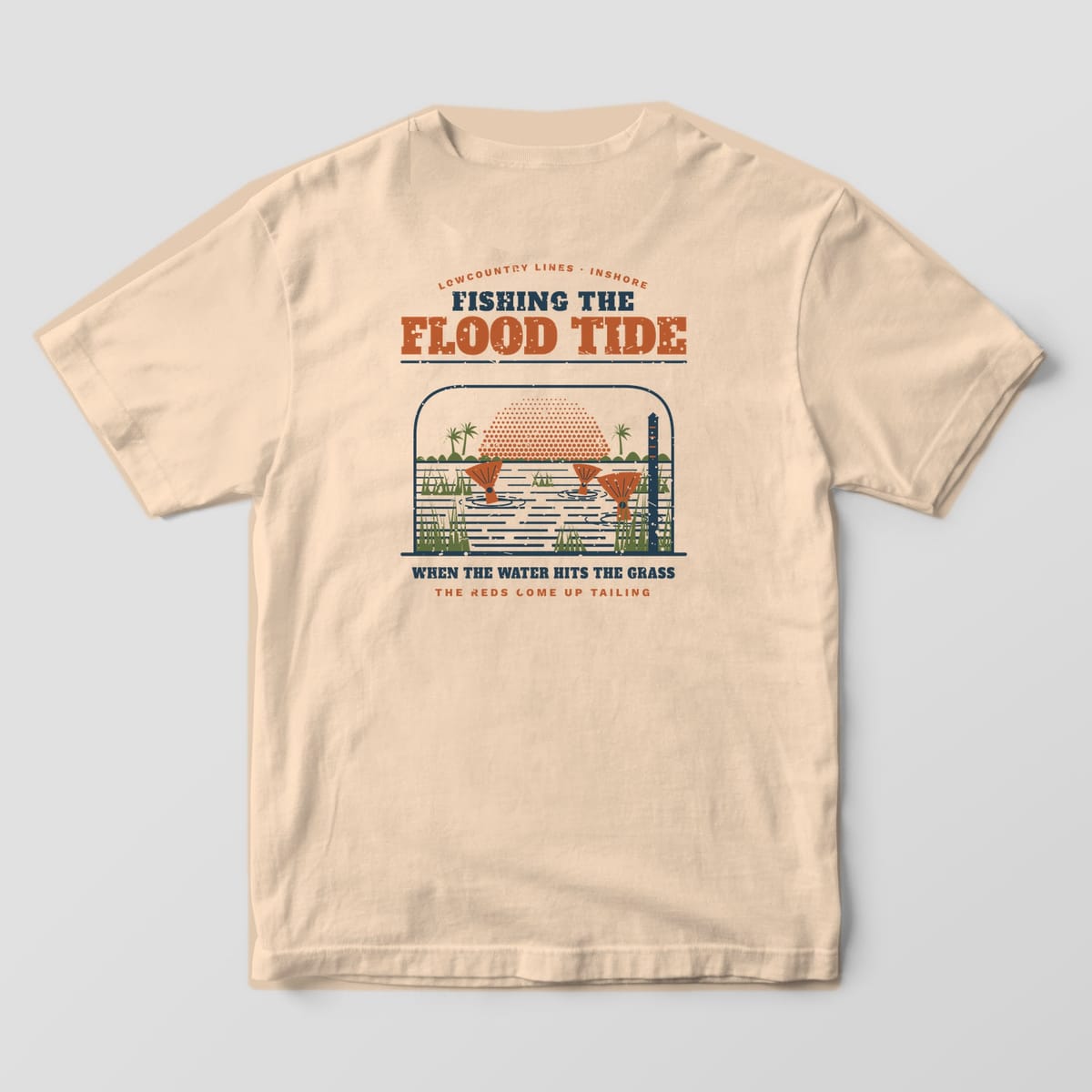 Ivory Comfort Colors tee, back view, with copper redfish tails in flooded marsh grass under the words Fishing the Flood Tide