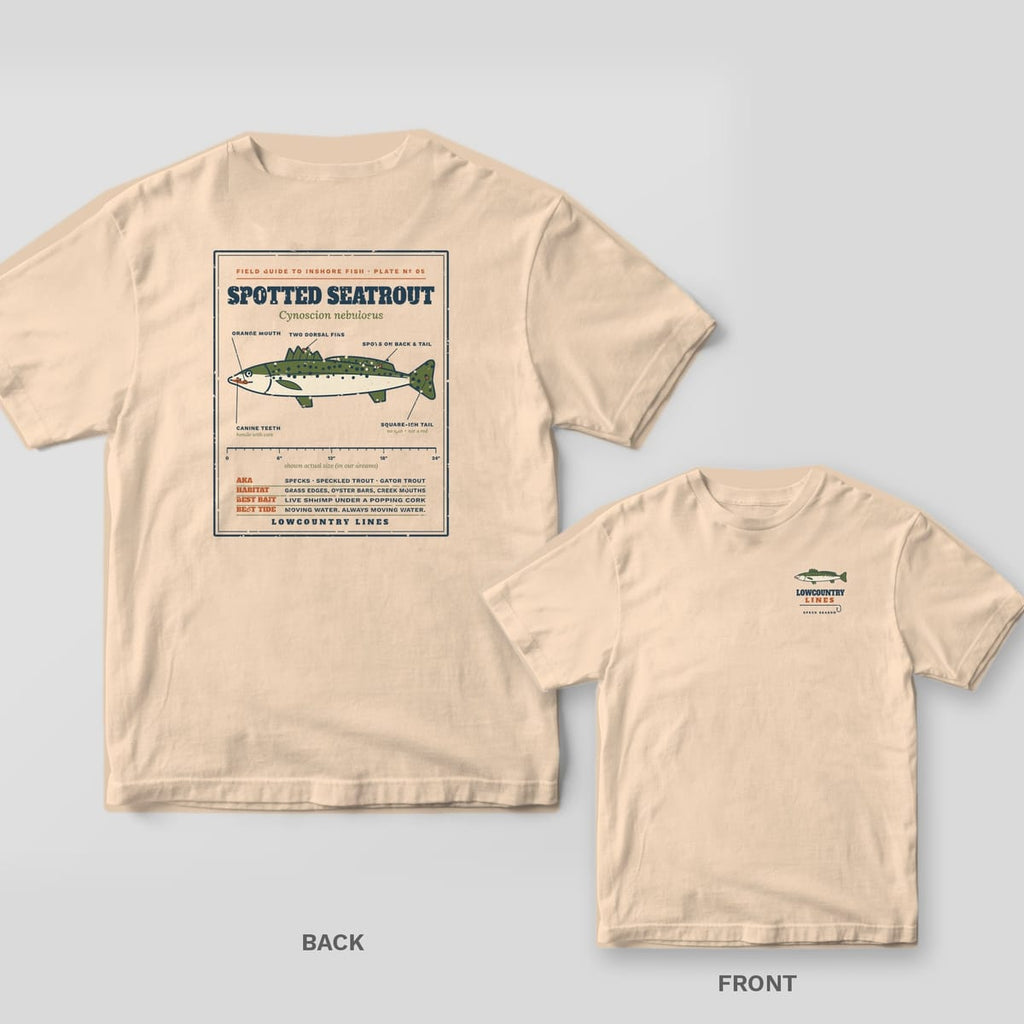 Back and front of an ivory T-shirt: back shows a field-guide plate of a spotted seatrout with labeled callouts; front has a small trout logo
