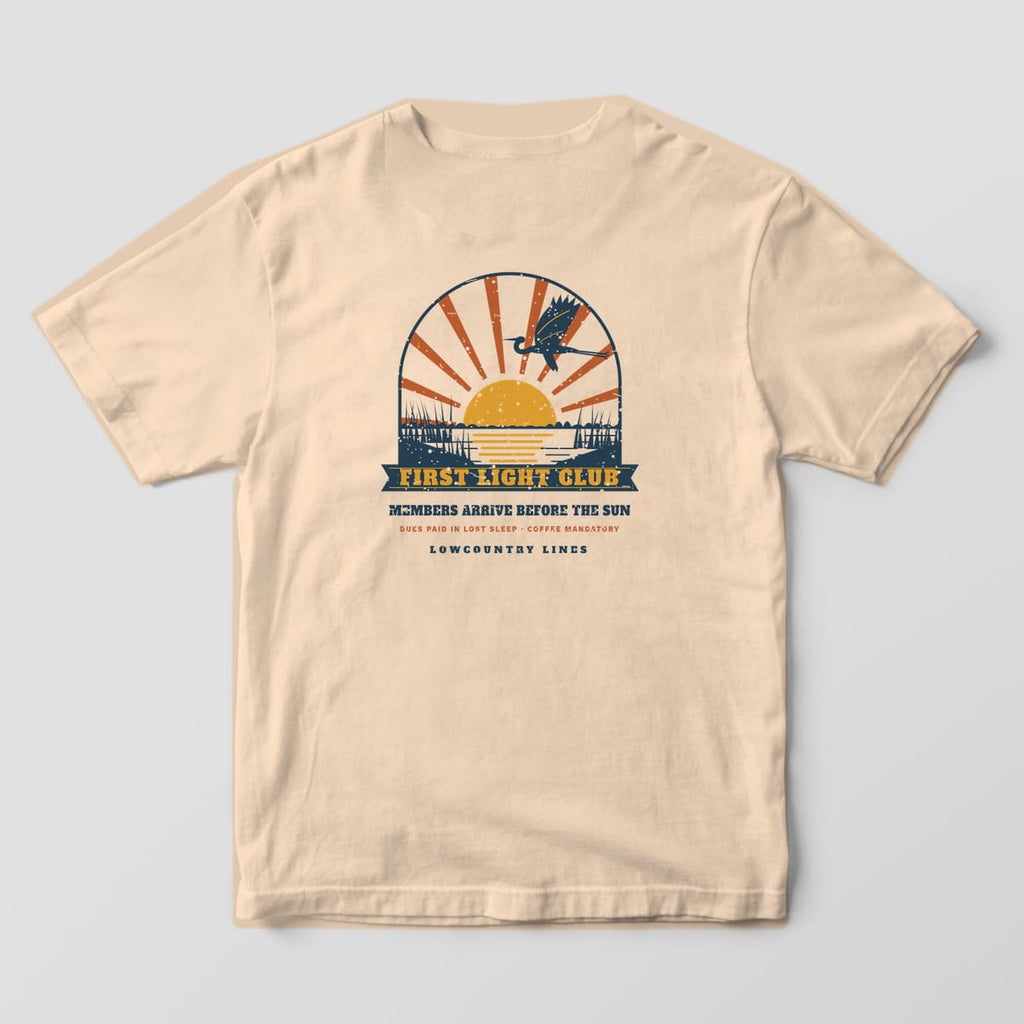 Ivory Comfort Colors tee, back view, with a sunrise over the marsh, a flying heron and a navy First Light Club banner