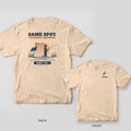 Back and front of an ivory T-shirt: back shows a heron and a wading angler in the marsh with Same Spot. Different Methods.; front has a small heron logo