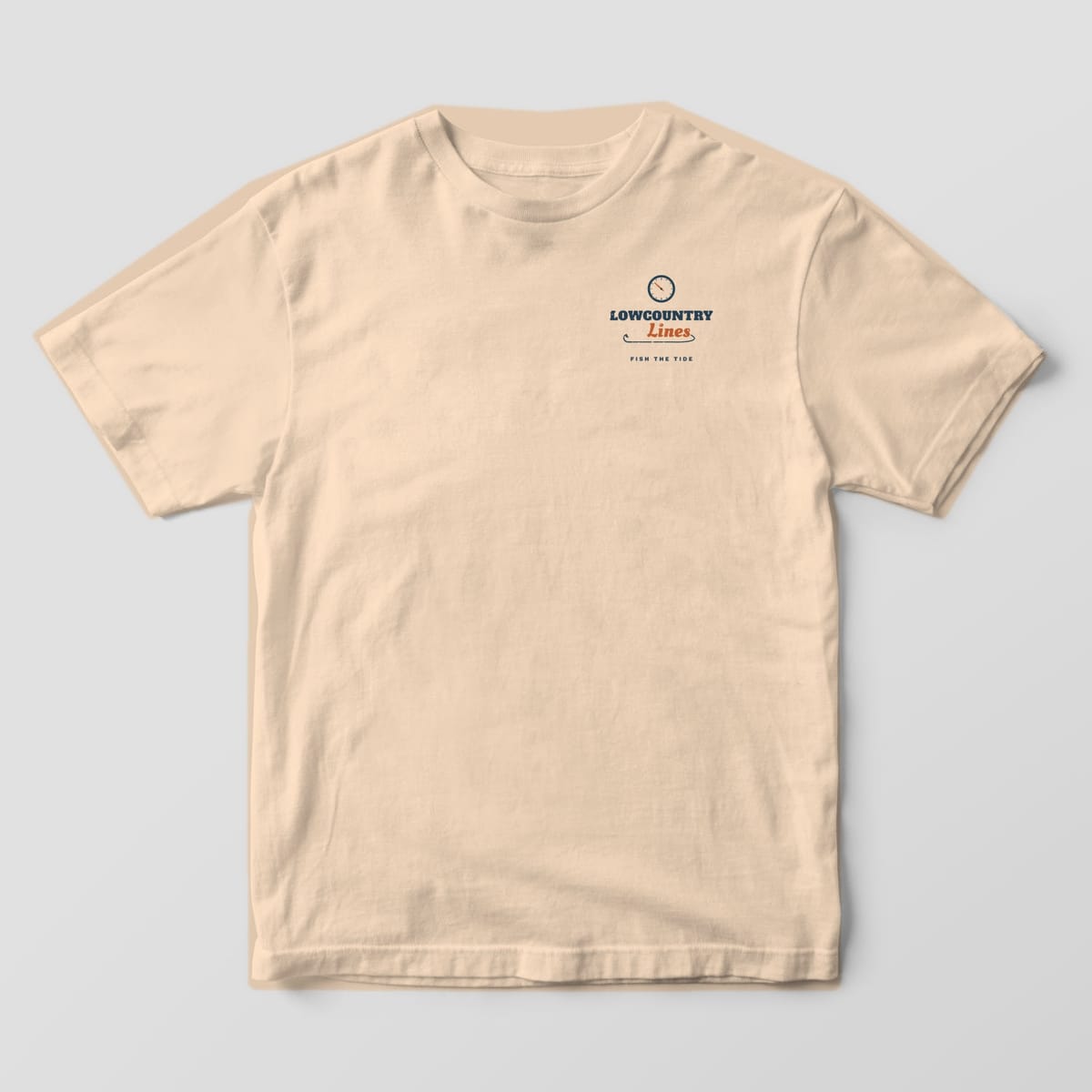 Ivory Comfort Colors tee, front view, with a small left-chest tide clock and Lowcountry Lines script wordmark
