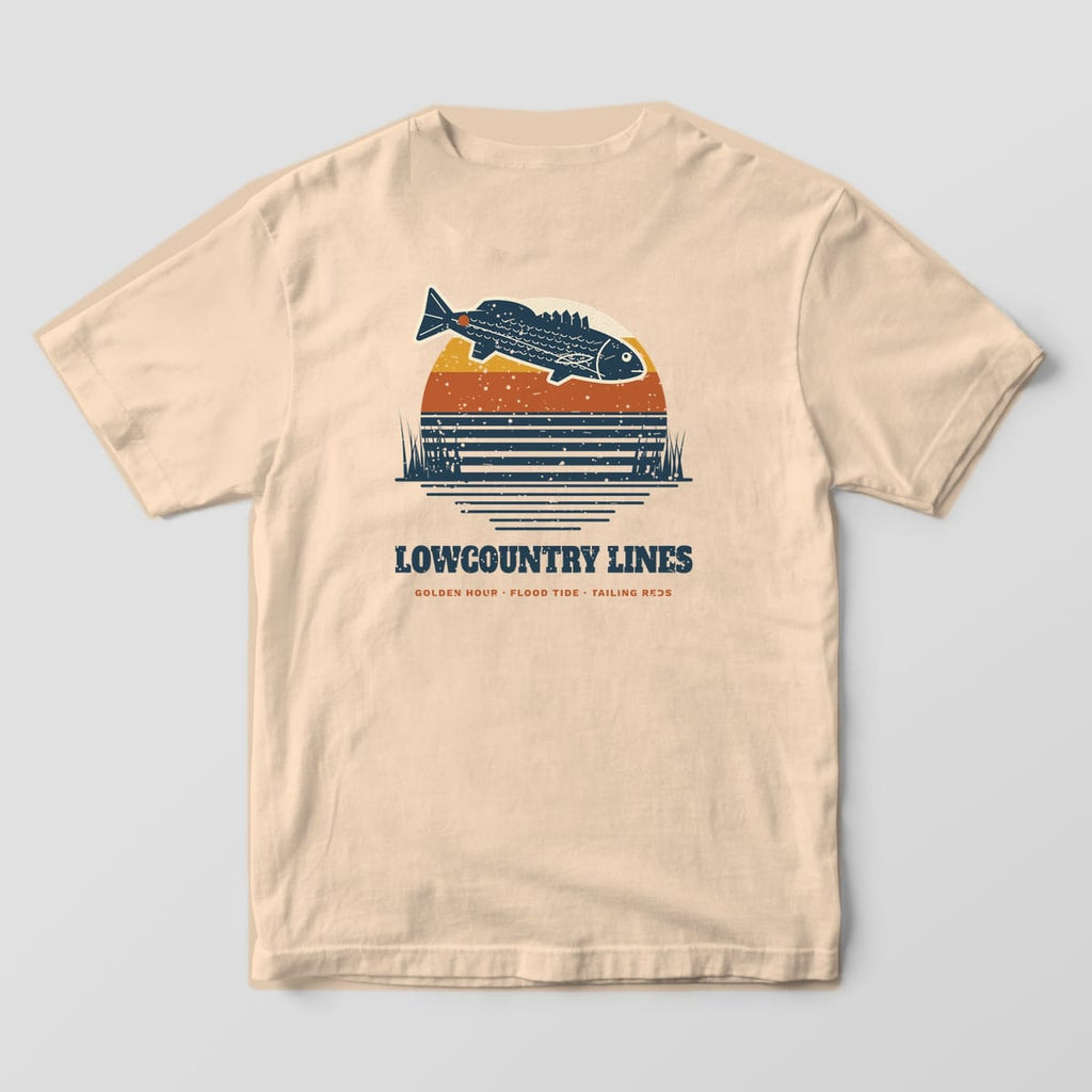 Ivory Comfort Colors tee, back view, with a retro striped sunset and leaping redfish above Lowcountry Lines