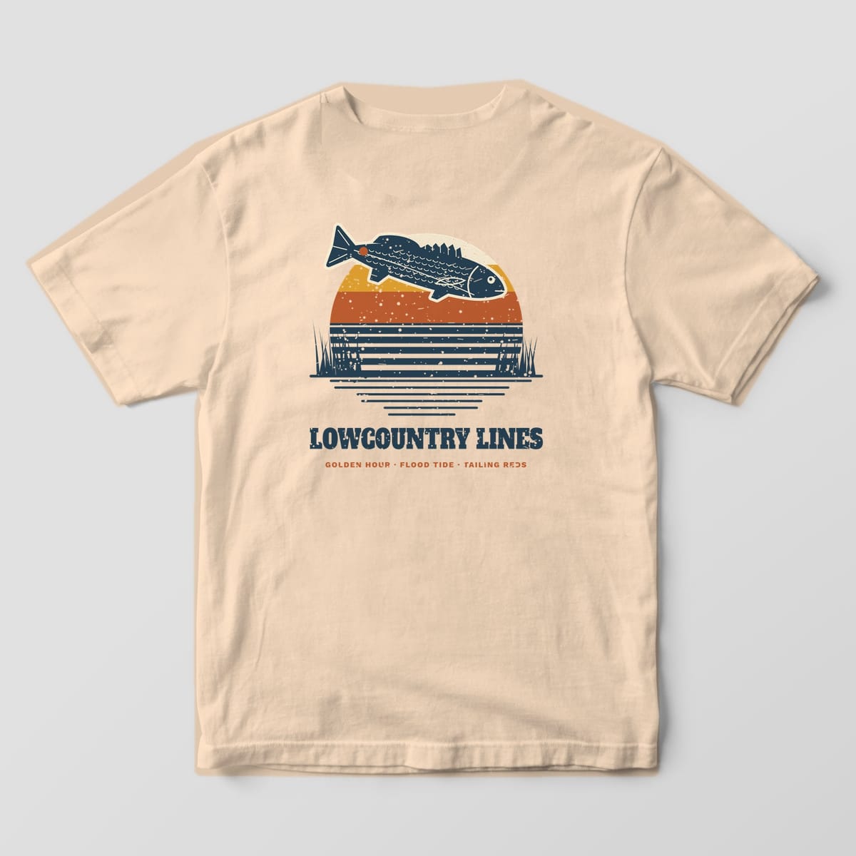 Ivory Comfort Colors tee, back view, with a retro striped sunset and leaping redfish above Lowcountry Lines