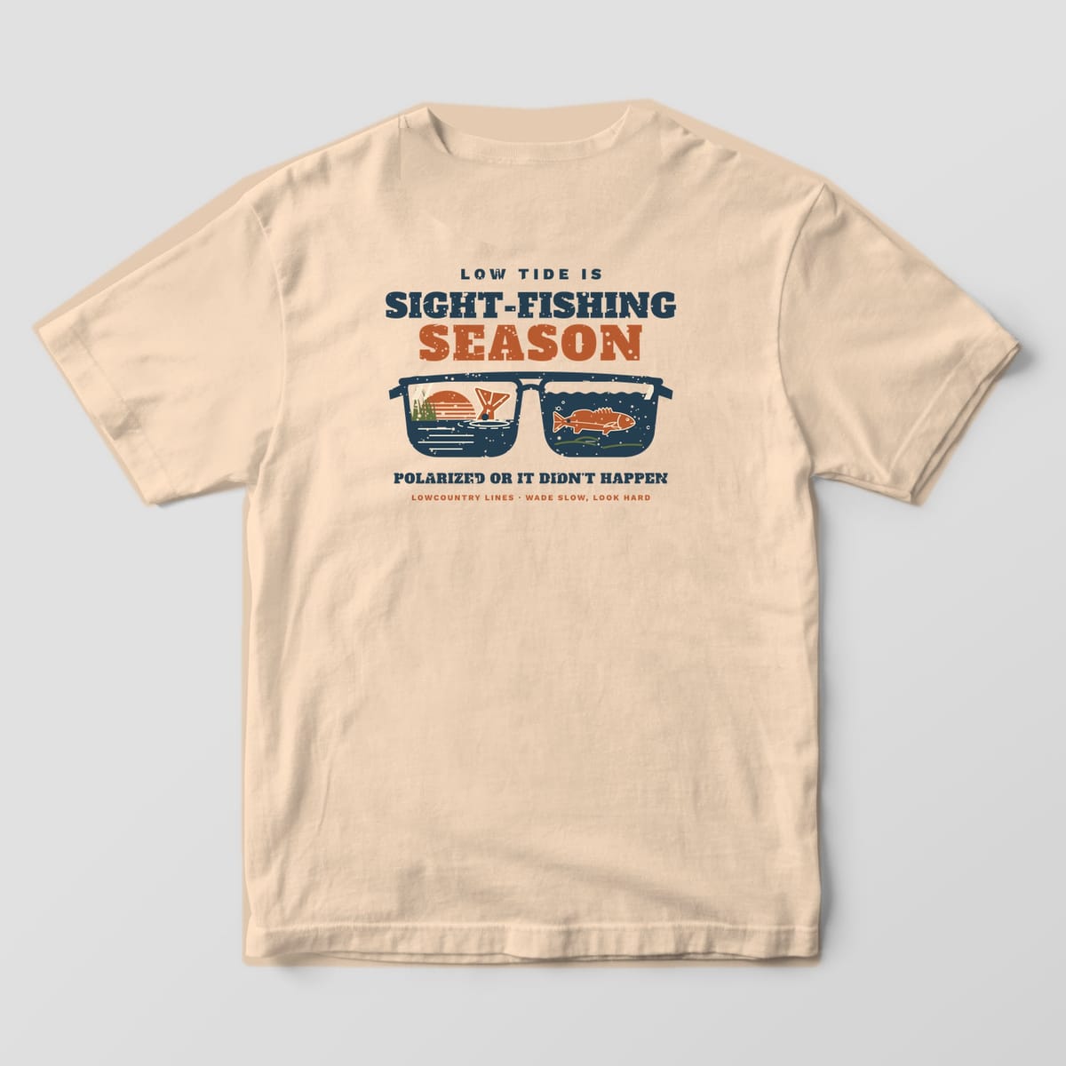 Ivory Comfort Colors tee, back view, with navy sunglasses showing a tailing redfish and an underwater redfish in the lenses
