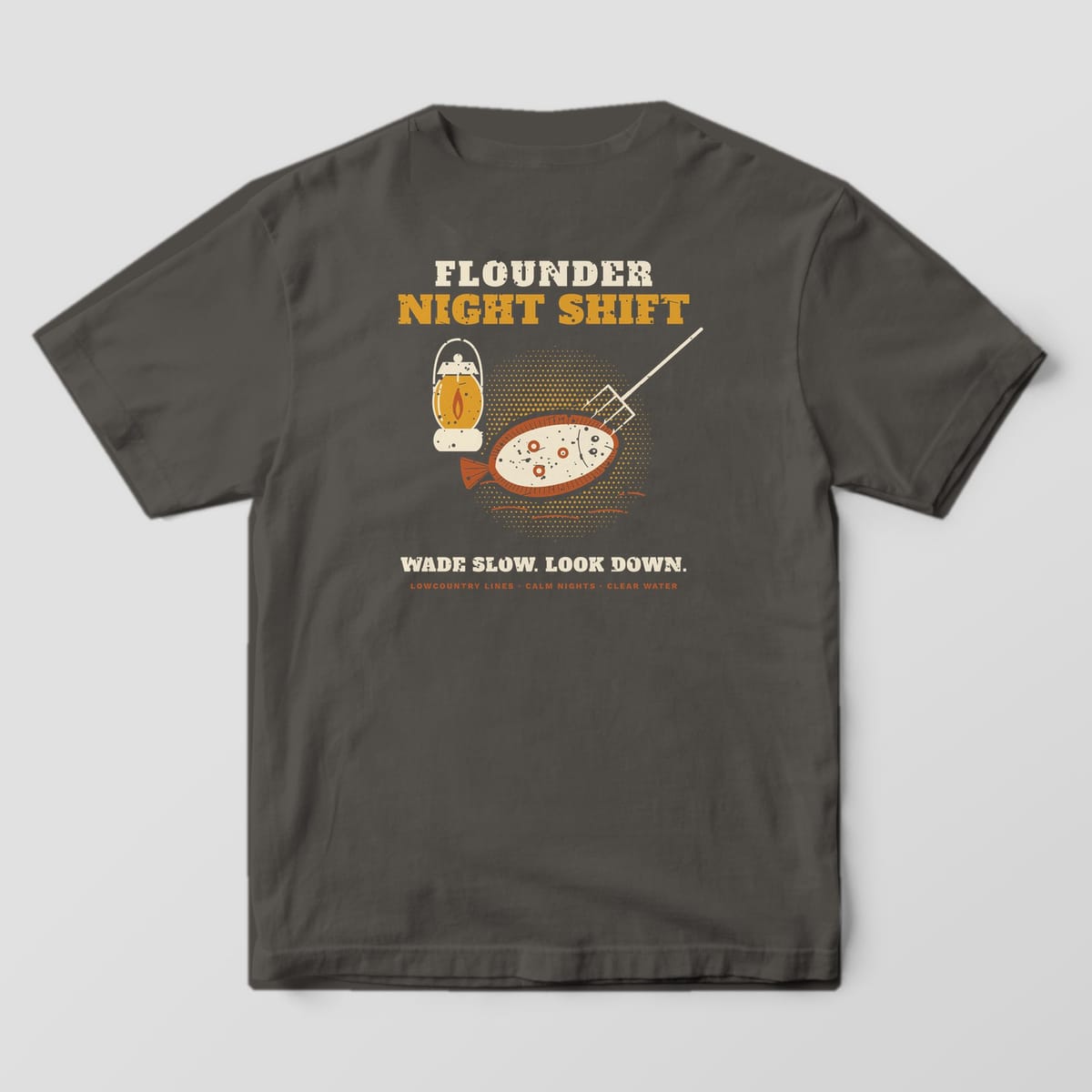 Pepper Comfort Colors tee, back view, with Flounder Night Shift lettering, a lantern, a gig and a flounder in a gold halftone glow