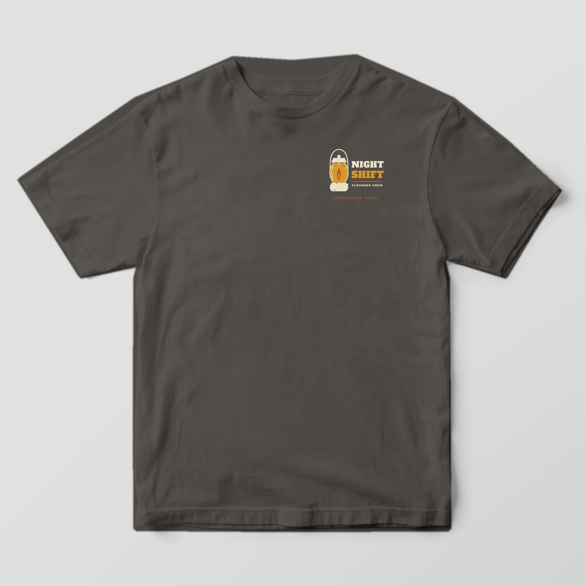 Pepper Comfort Colors tee, front view, with a small left-chest lantern and Night Shift, Flounder Crew lettering