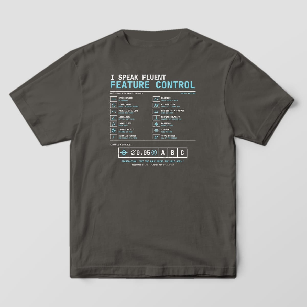 Back of a Pepper Comfort Colors 1717 tee with a cyan and off-white chart of 14 GD&T symbols with joke translations and a large feature control frame.