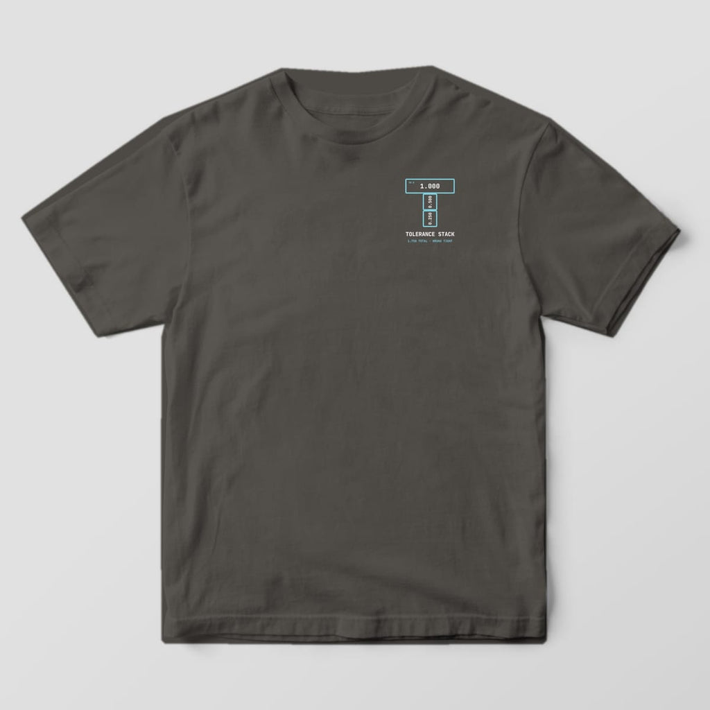 Front of a Pepper Comfort Colors 1717 tee with a small left-chest letter T made of three gauge blocks above the words Tolerance Stack.