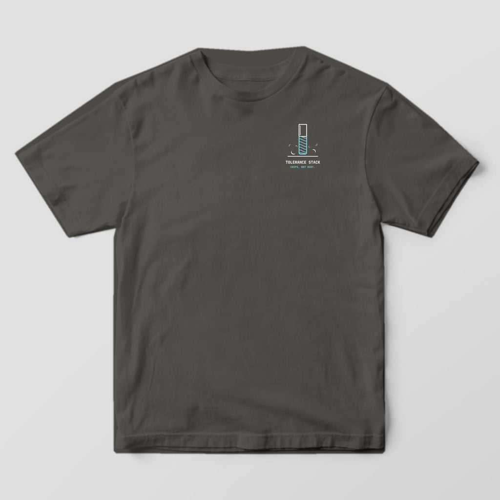 Front of a Pepper Comfort Colors 1717 tee with a small left-chest end mill and chips above the words Tolerance Stack.