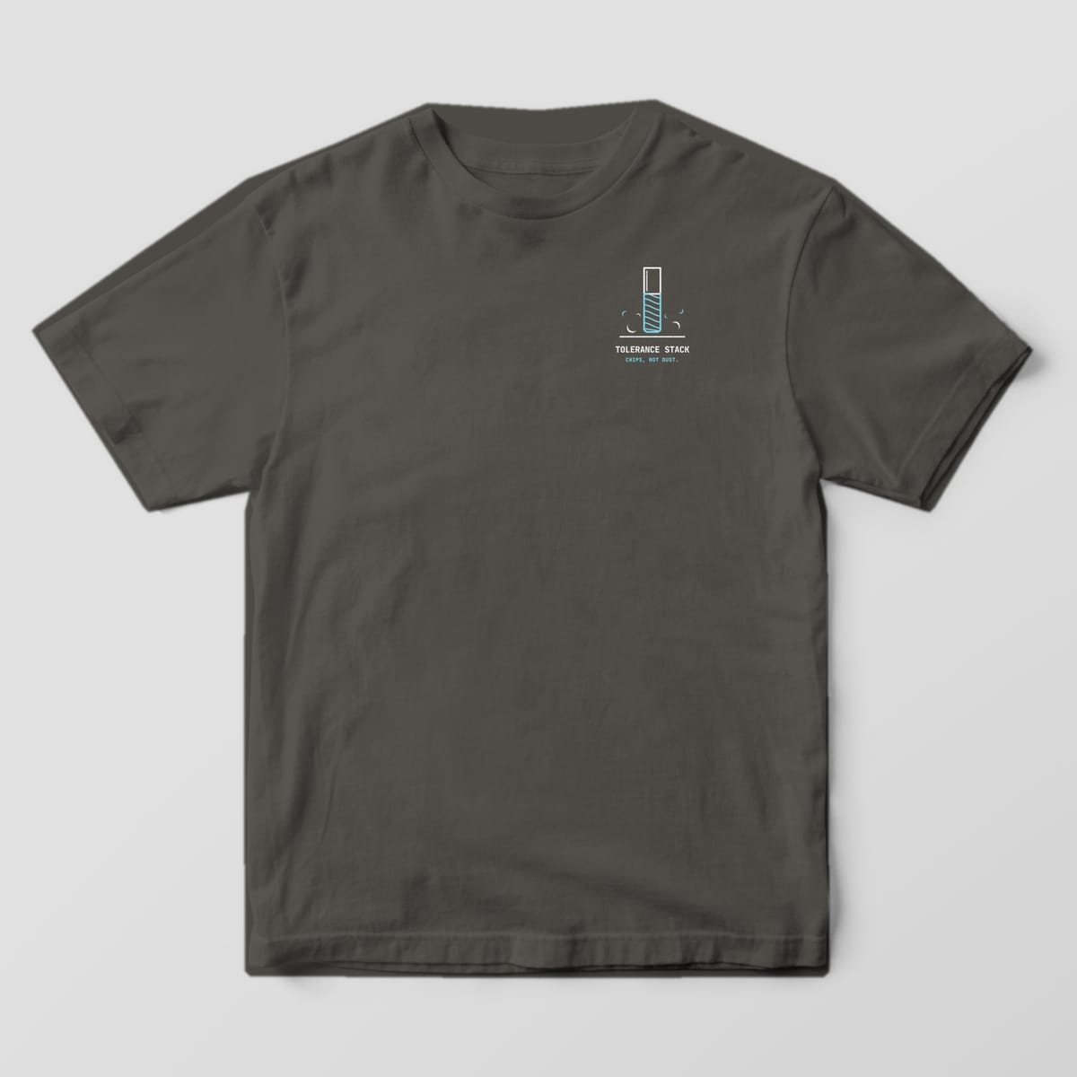 Front of a Pepper Comfort Colors 1717 tee with a small left-chest end mill and chips above the words Tolerance Stack.