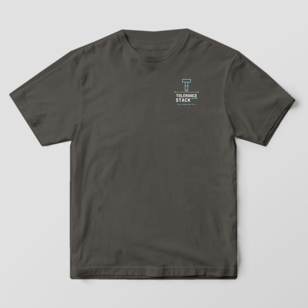 Front of a Pepper Comfort Colors 1717 tee with a small left-chest gauge-block T, a REF dimension line and the Tolerance Stack wordmark.