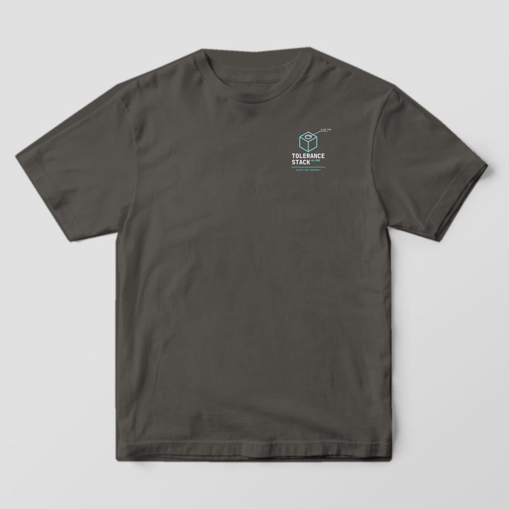 Front of a Pepper Comfort Colors 1717 tee with a small isometric cube with a hole above the words Tolerance Stack.