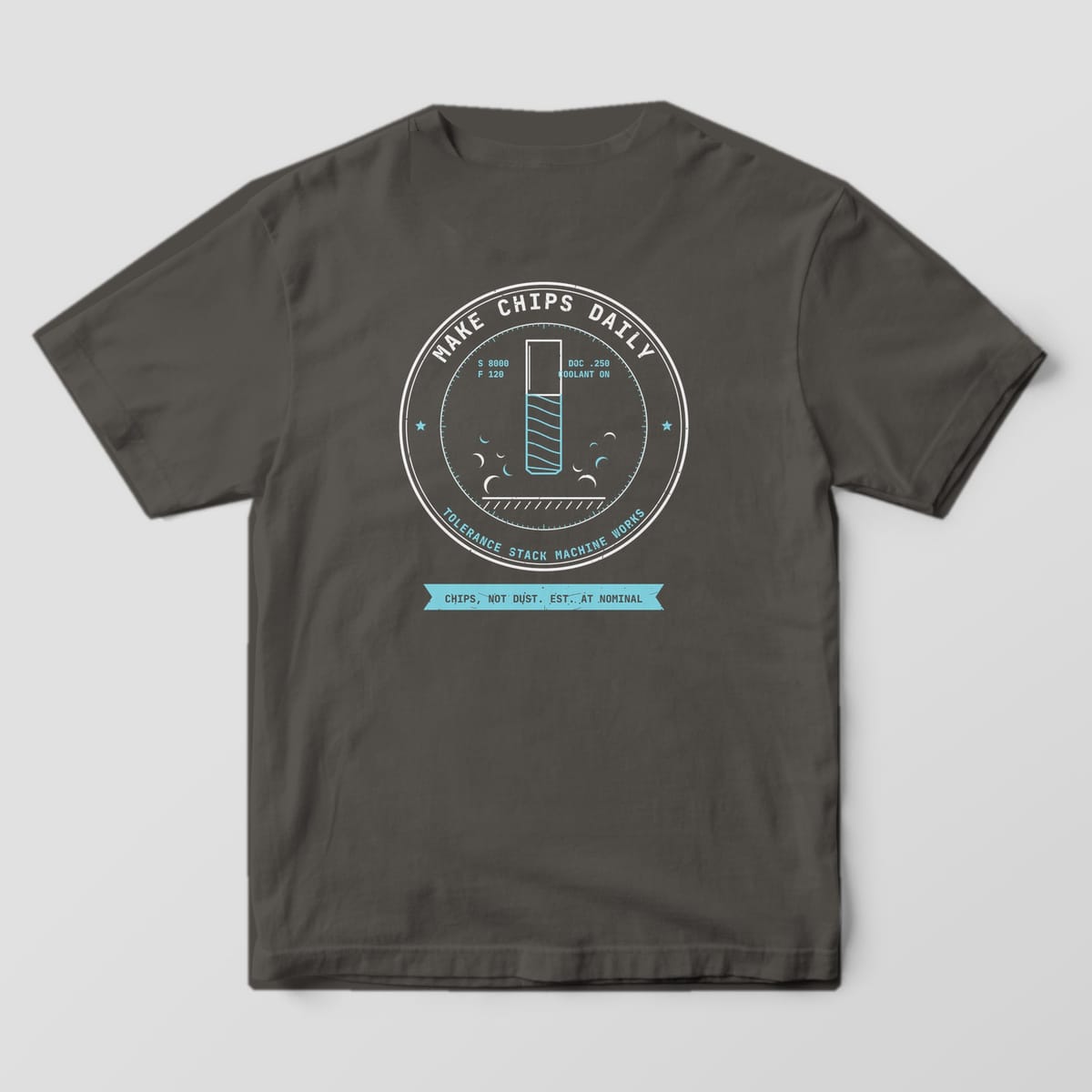 Back of a Pepper Comfort Colors 1717 tee with a large off-white and cyan Make Chips Daily badge showing an end mill and flying chips.