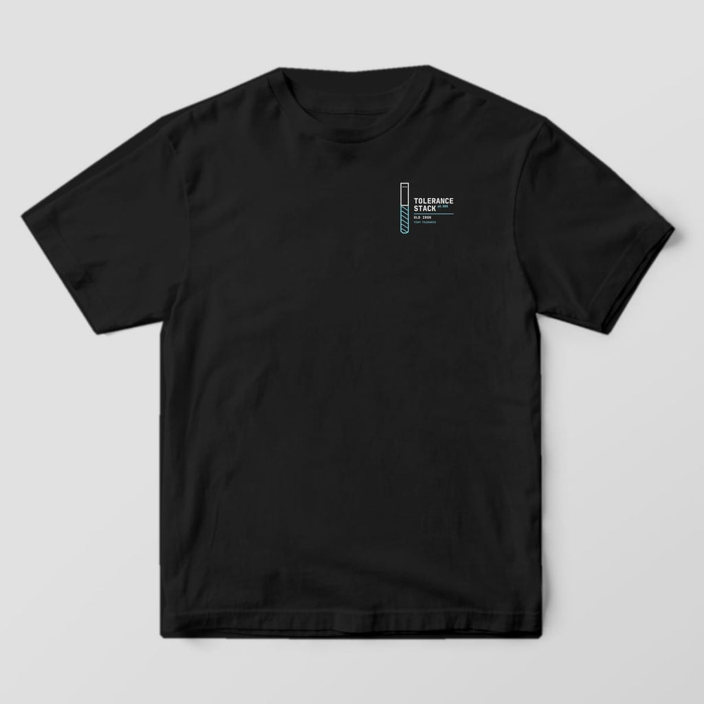 Front of a Black Comfort Colors 1717 tee with a small left-chest end mill beside the words Tolerance Stack.