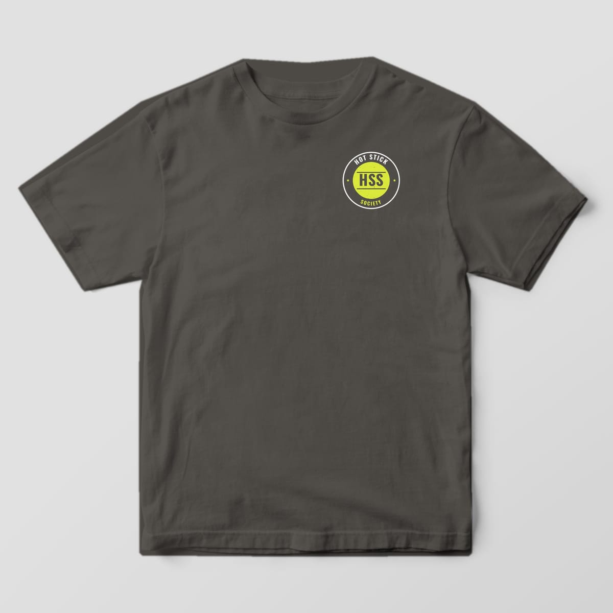 Front view of the pepper Comfort Colors 1717 shirt with the small left-chest We Go When You Can't print