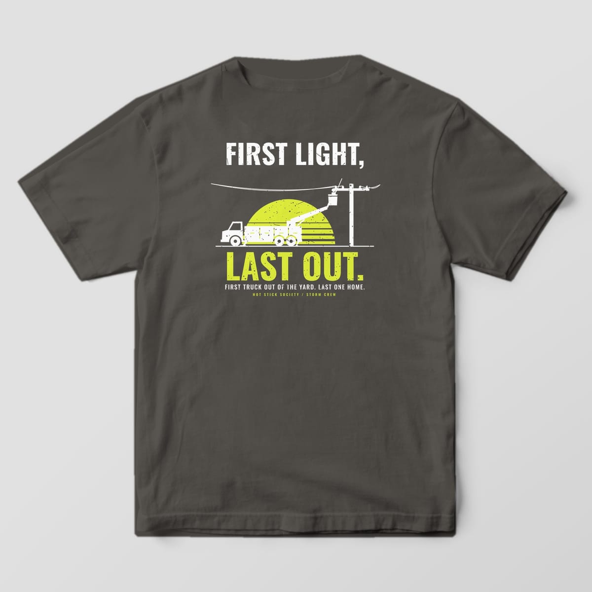 Back view of the pepper Comfort Colors 1717 shirt showing the First Light Last Out Bucket Truck back print in hi-vis yellow and white