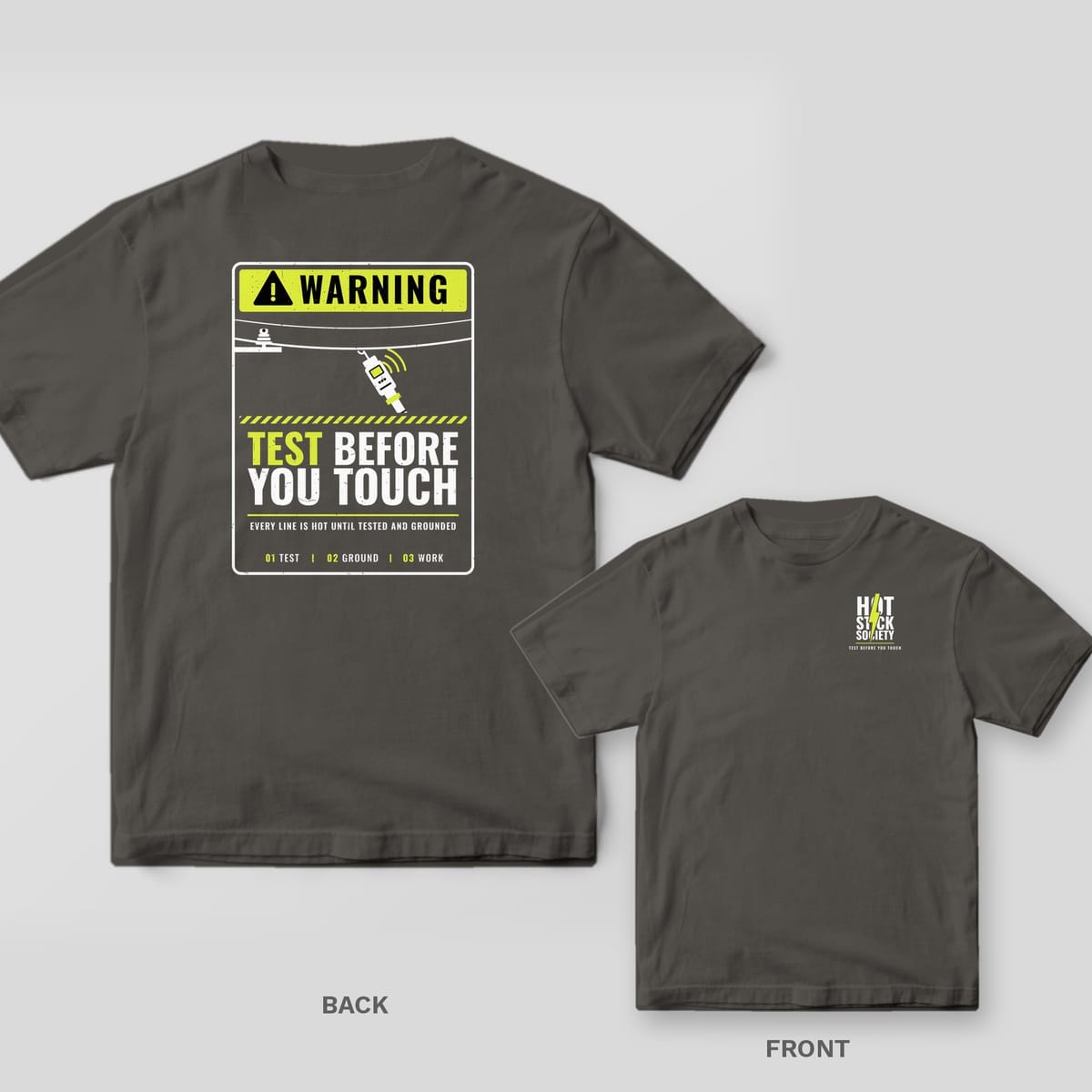 Back and front of a pepper Test Before You Touch warning-sign lineman T-shirt shown together, back print large on the left and the small chest print on the right