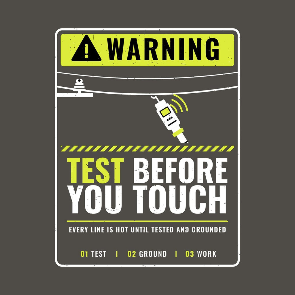 Close-up of the Test Before You Touch warning-sign print artwork in hi-vis yellow and white on a dark background