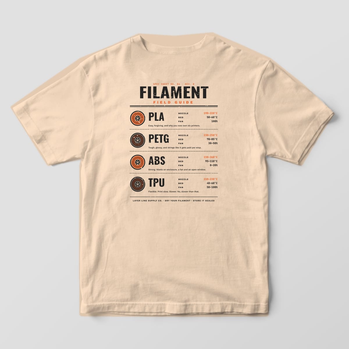 Back print on an Ivory Comfort Colors 1717 tee: "Filament Field Guide" spec sheet with spool icons and nozzle, bed and fan ranges for PLA, PETG, ABS and TPU, plus a one-line note for each