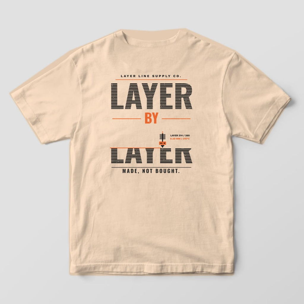 Back print on an Ivory Comfort Colors 1717 tee: Giant "Layer by Layer" type made of horizontal layer stripes, the bottom word half printed under a working nozzle, with "Made, Not Bought." below