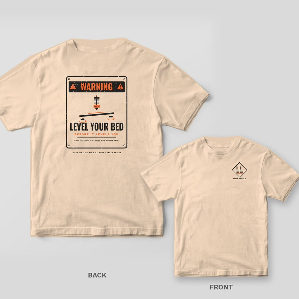 Level Your Bed Warning Sign 3D printing shirt shown back and front on Ivory Comfort Colors 1717: Distressed warning sign: "Warning" header, nozzle over a tilted print bed with knobs, "Level Your Bed, Before It Levels You" and "Paper test.…