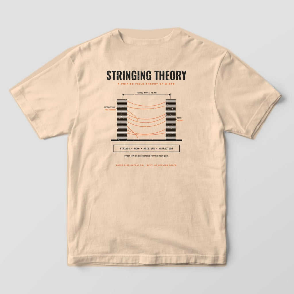 Back print on an Ivory Comfort Colors 1717 tee: "Stringing Theory" diagram of two striped towers with orange strings, labeled travel move, retraction and PETG notes, plus "Strings = Temp × Moisture ÷ Retraction"