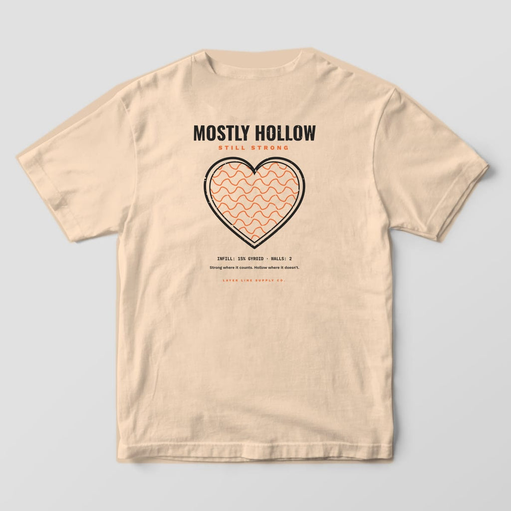 Back print on an Ivory Comfort Colors 1717 tee: "Mostly Hollow / Still Strong" over a large double-walled heart filled with orange gyroid infill, with "Infill: 15% Gyroid · Walls: 2"