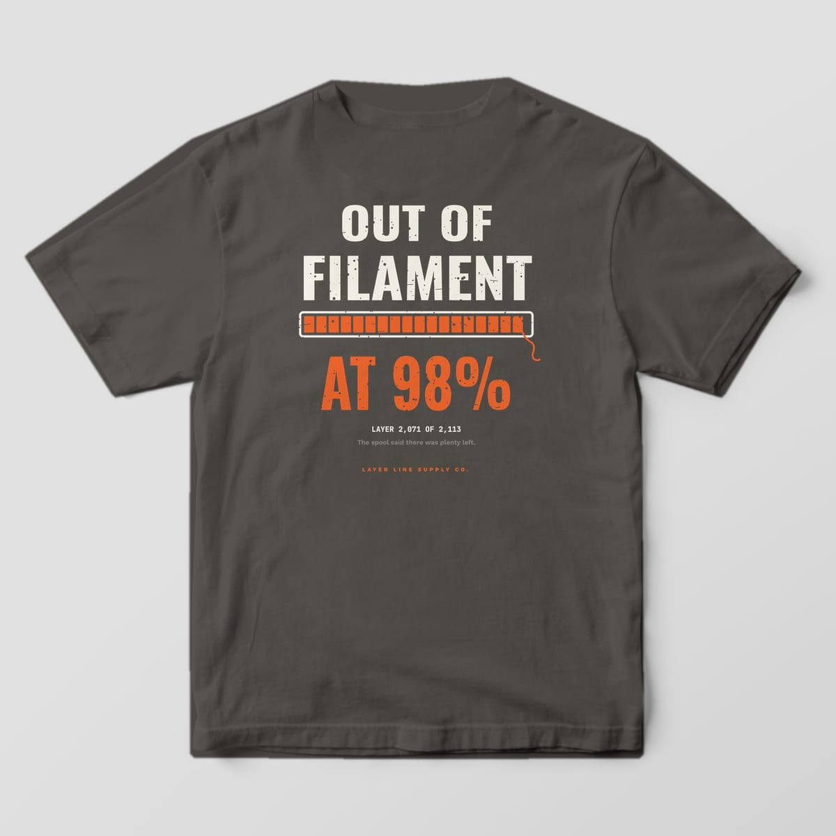 Back print on a Pepper Comfort Colors 1717 tee: "Out of Filament" over an orange progress bar stopped at 98% with a dangling filament end, "At 98%" in big orange type and "Layer 2,071 of 2,113"
