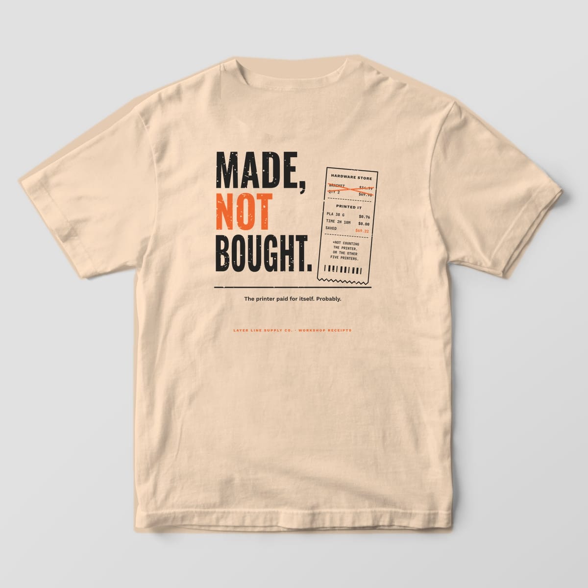 Back print on an Ivory Comfort Colors 1717 tee: Stacked "Made, Not Bought." in charcoal and orange next to a tilted receipt comparing a hardware-store bracket to a 76-cent printed one, with "The printer paid for itself. Probably."