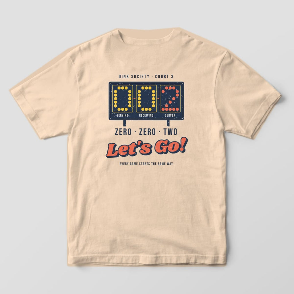 Back print on an Ivory Comfort Colors 1717 tee: Navy retro scoreboard reading 0-0-2 in yellow and coral dots with Zero Zero Two Let's Go text
