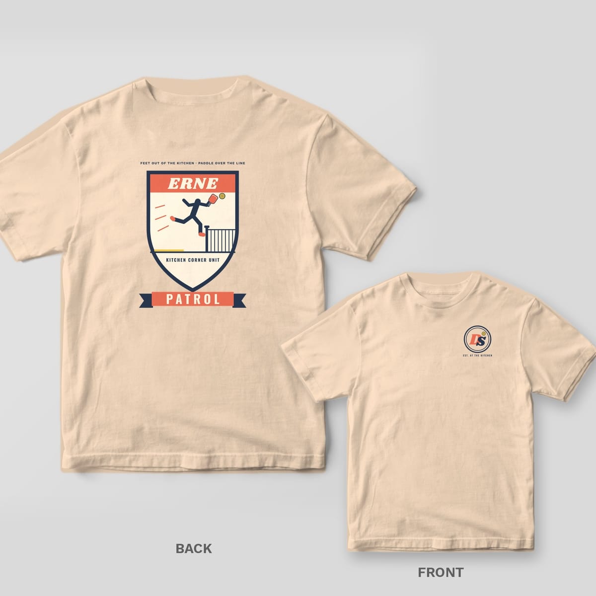 Erne Patrol pickleball shirt shown back and front on Ivory Comfort Colors 1717: Erne Patrol shield badge with a navy player leaping past the net post holding a coral paddle