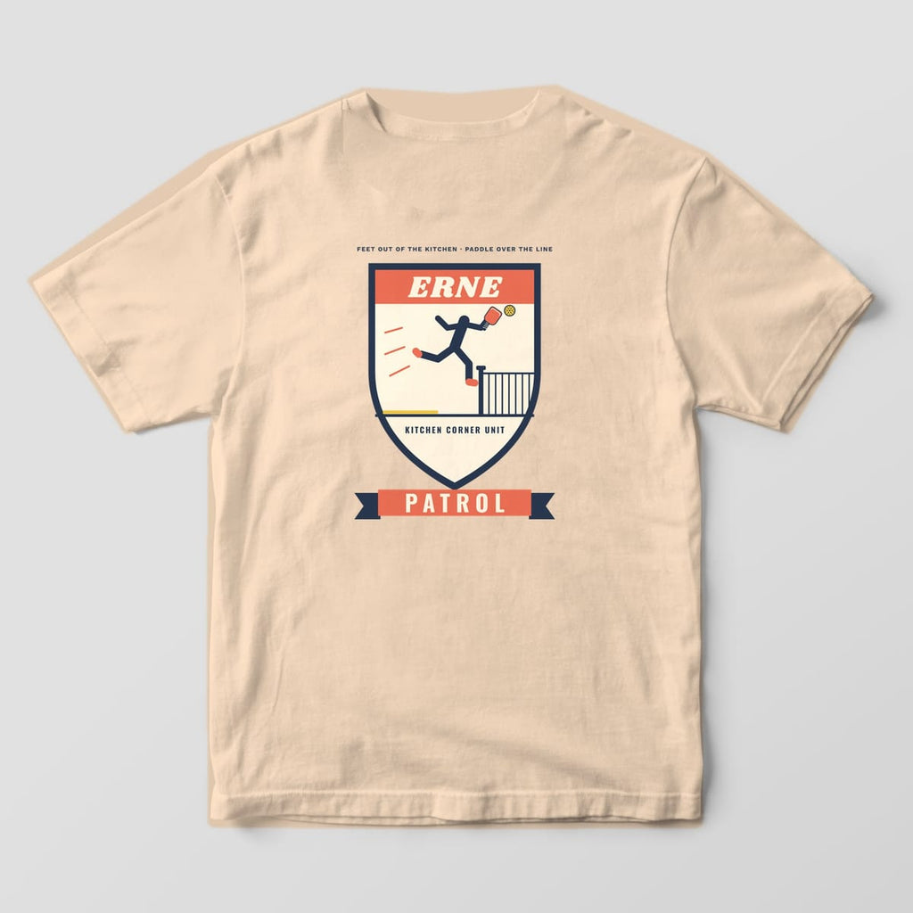 Back print on an Ivory Comfort Colors 1717 tee: Erne Patrol shield badge with a navy player leaping past the net post holding a coral paddle