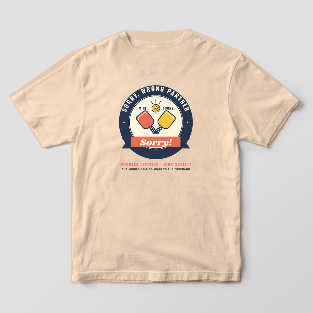 Back print on an Ivory Comfort Colors 1717 tee: Round Sorry Wrong Partner badge with coral and yellow paddles labeled Mine and Yours under a ball