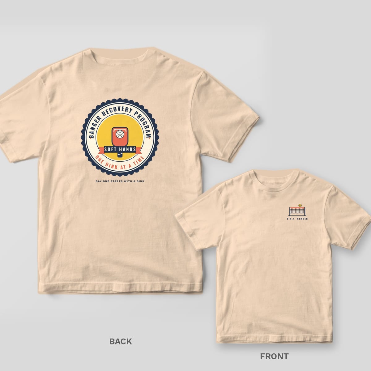 Banger Recovery Program pickleball shirt shown back and front on Ivory Comfort Colors 1717: Scalloped Banger Recovery Program seal with a coral paddle, Soft Hands ribbon and One Dink at a Time