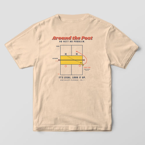 Back print on an Ivory Comfort Colors 1717 tee: Overhead pickleball court diagram with a coral arrow sending the ball around the net post