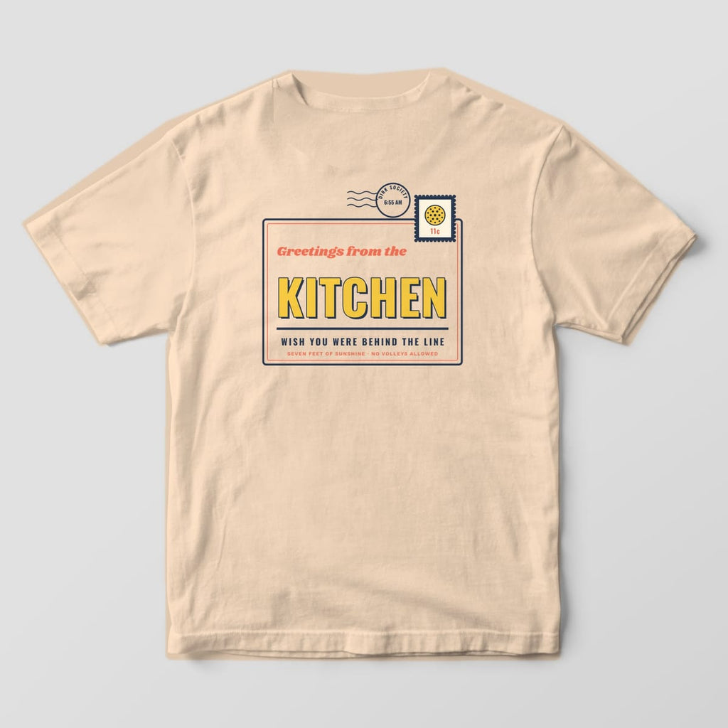Back print on an Ivory Comfort Colors 1717 tee: Vintage postcard design reading Greetings from the Kitchen with a pickleball stamp and postmark