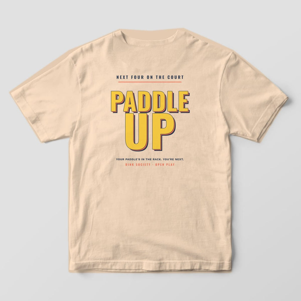 Back print on an Ivory Comfort Colors 1717 tee: Stacked yellow block letters reading Paddle Up with coral and navy shadows