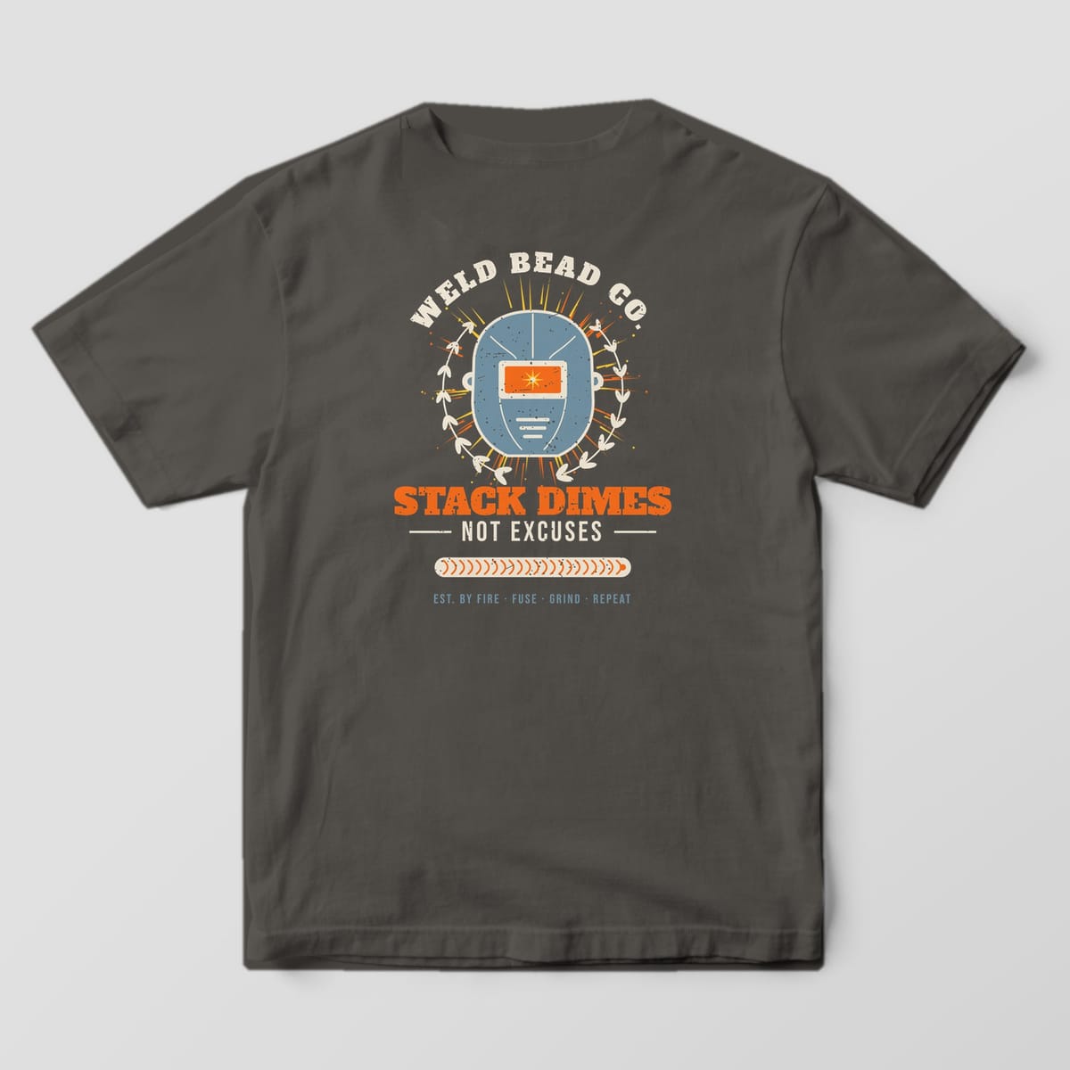 Back print on a Pepper Comfort Colors 1717 tee: "Stack Dimes, Not Excuses" under a large welding hood badge with laurels, sparks and an arched "Weld Bead Co.", finished with a stacked-dime bead bar