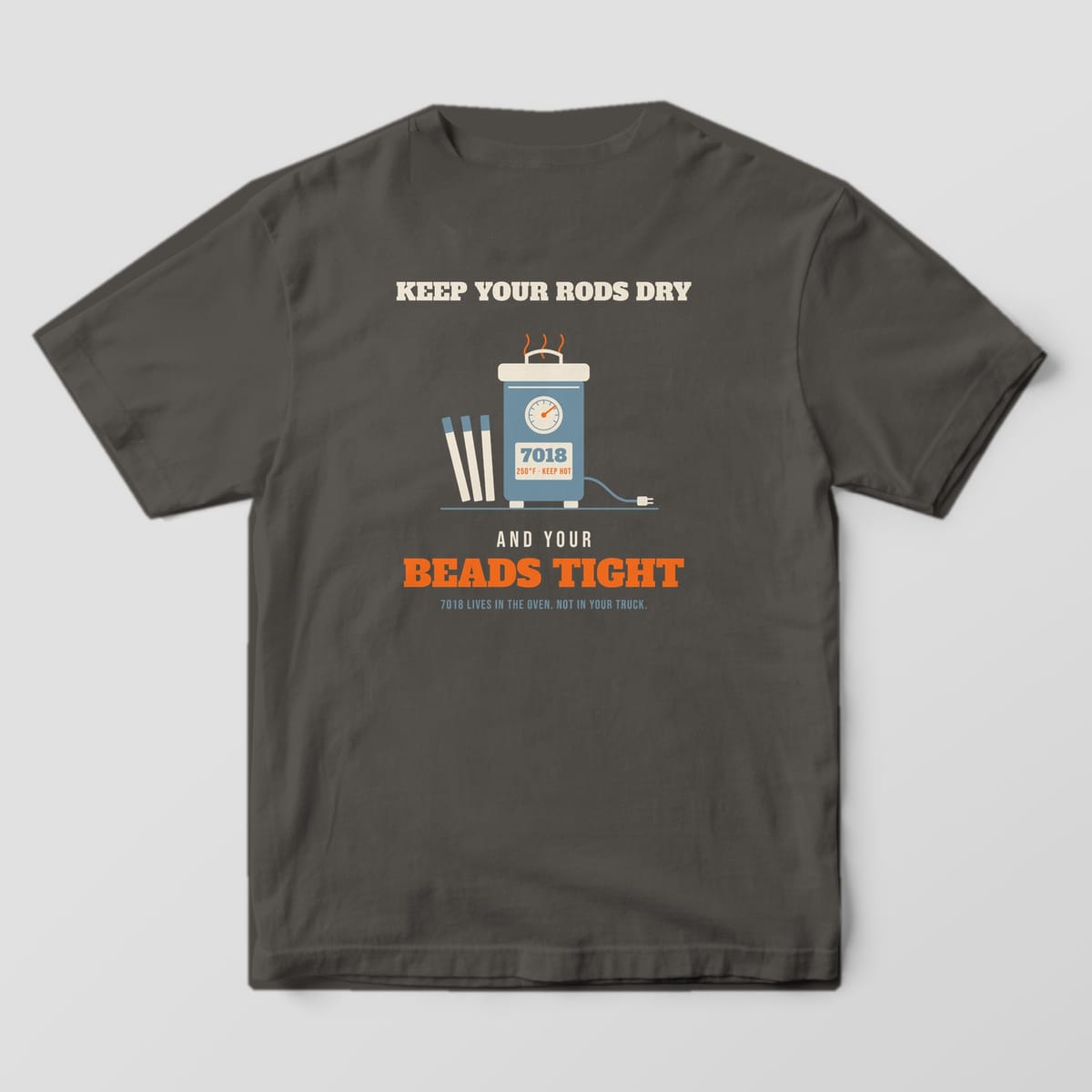 Back print on a Pepper Comfort Colors 1717 tee: A rod oven with a temperature gauge and electrodes under "Keep Your Rods Dry", with "And Your Beads Tight" and "7018 Lives in the Oven. Not in Your Truck."