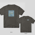 Certified Fabricator Tag (custom name) welder shirt shown back and front on Pepper Comfort Colors 1717: A hanging steel ID tag: "Certified Fabricator", the custom name, ID number and a spec list (process, position, bend test, blood type: argon)