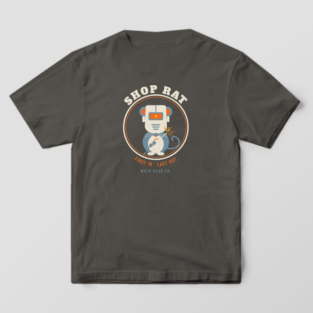 Back print on a Pepper Comfort Colors 1717 tee: Round badge with a rat wearing a welding hood and holding a torch, "Shop Rat" arched above and "First In · Last Out" below