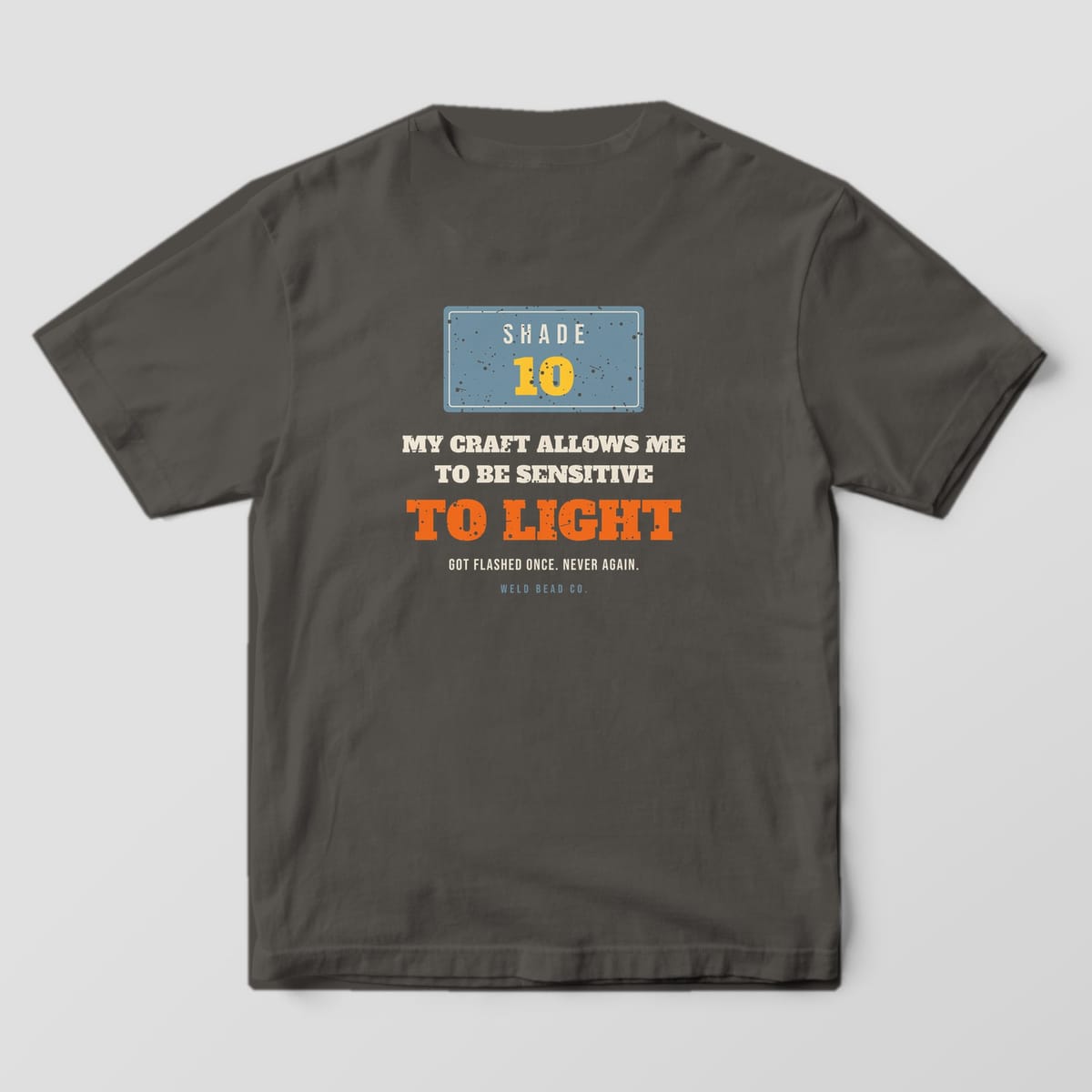 Back print on a Pepper Comfort Colors 1717 tee: A Shade 10 lens plate over "My Craft Allows Me to Be Sensitive to Light" and "Got Flashed Once. Never Again."