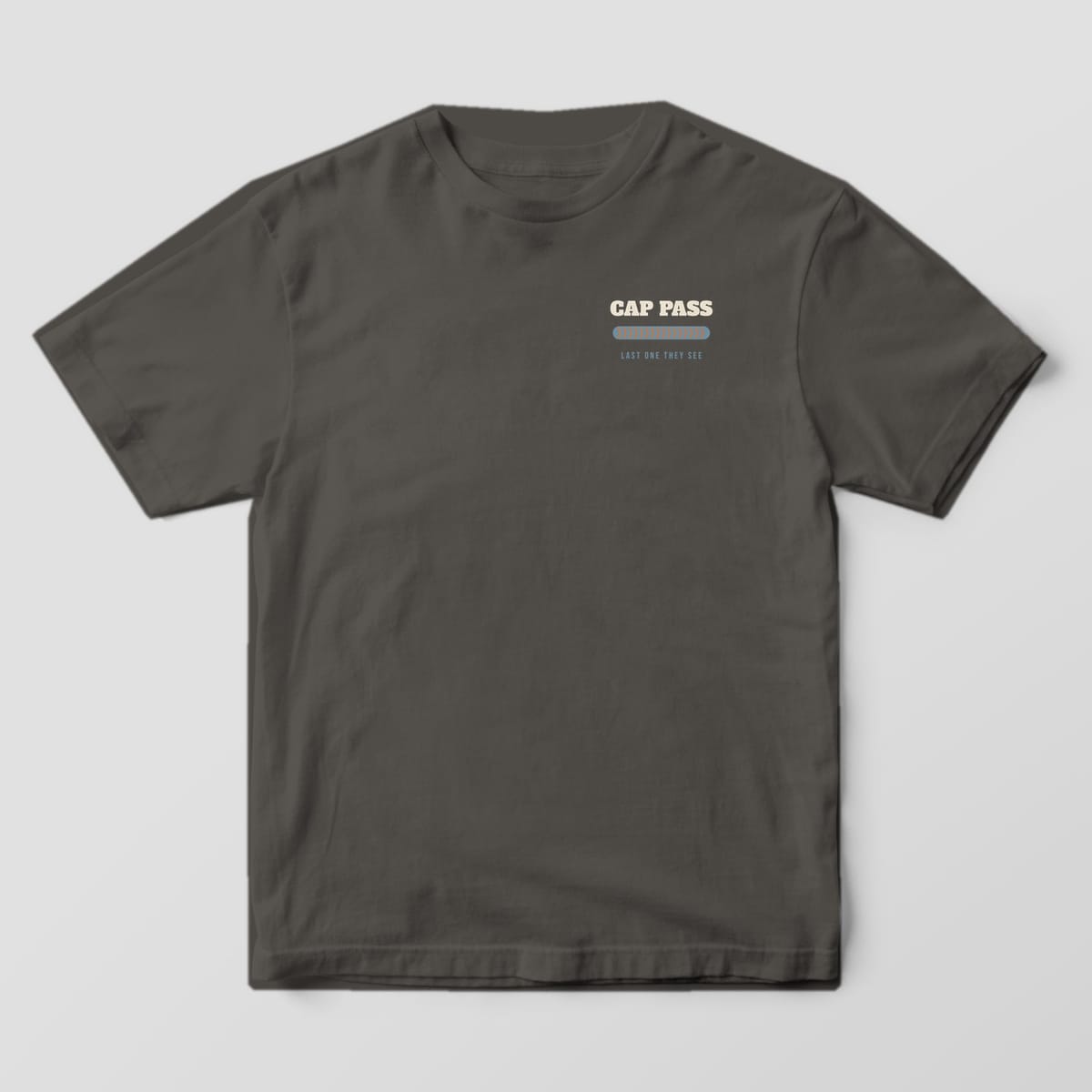 Front of the Pepper Comfort Colors 1717 tee showing the left-chest print: Left-chest "Cap Pass" over a stacked-dime bead and "Last One They See"