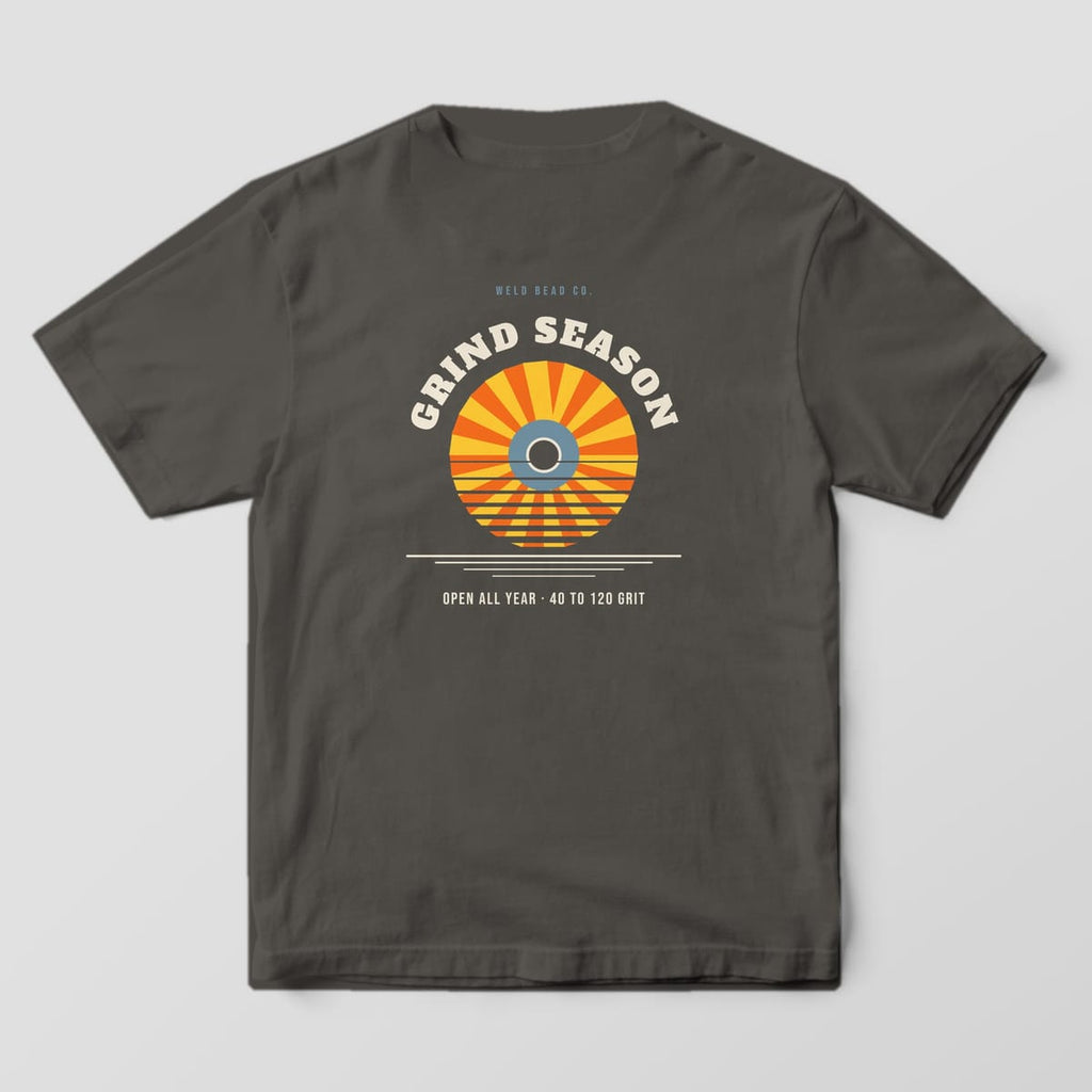 Back print on a Pepper Comfort Colors 1717 tee: Arched "Grind Season" over a flap disc drawn as a striped retro sunset, with "Open All Year · 40 to 120 Grit"