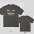 Union Strong welder shirt shown back and front on Pepper Comfort Colors 1717: Arched "Union Strong" over a gloved handshake with sparks, "One Trade. One Crew." and "Skilled Hands Built All of This"