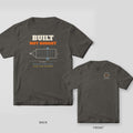 Built Not Bought welder shirt shown back and front on Pepper Comfort Colors 1717: "Built Not Bought" over a dimensioned trailer frame drawing, with "Drawn By: Me · Checked By: Also Me" and "2x3 Tube · 3/16 Wall · No Kit Required"