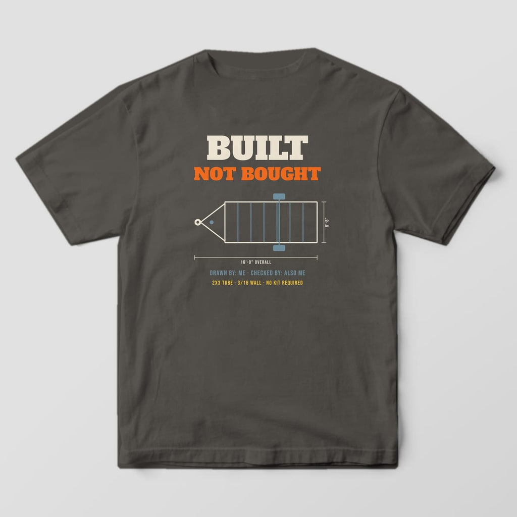 Back print on a Pepper Comfort Colors 1717 tee: "Built Not Bought" over a dimensioned trailer frame drawing, with "Drawn By: Me · Checked By: Also Me" and "2x3 Tube · 3/16 Wall · No Kit Required"