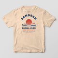 Front of an ivory Comfort Colors T-shirt with a full front print of two anchored boats at a sandbar under a striped sunset with the words Sandbar Social Club