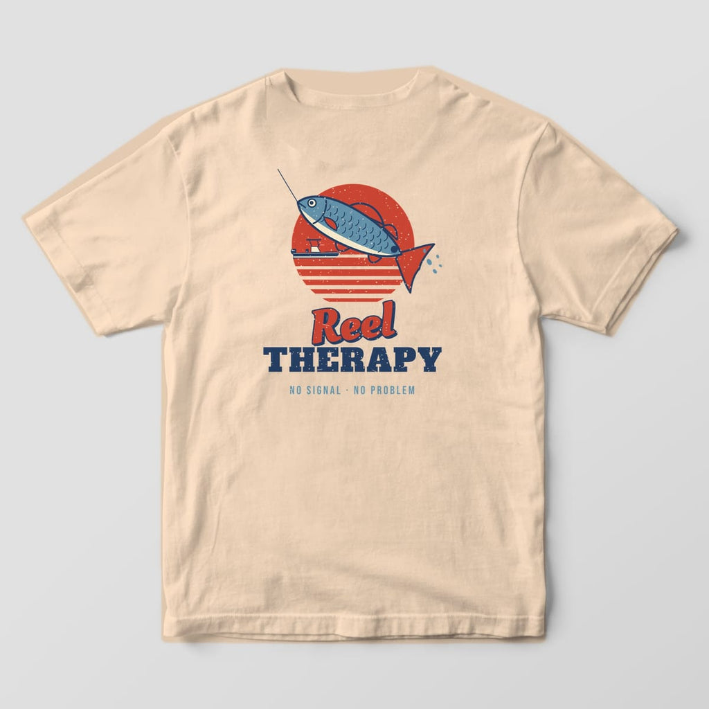 Back of an ivory Comfort Colors 1717 T-shirt showing the retro sunset with a leaping fish on a fishing line, a small boat and the words Reel Therapy