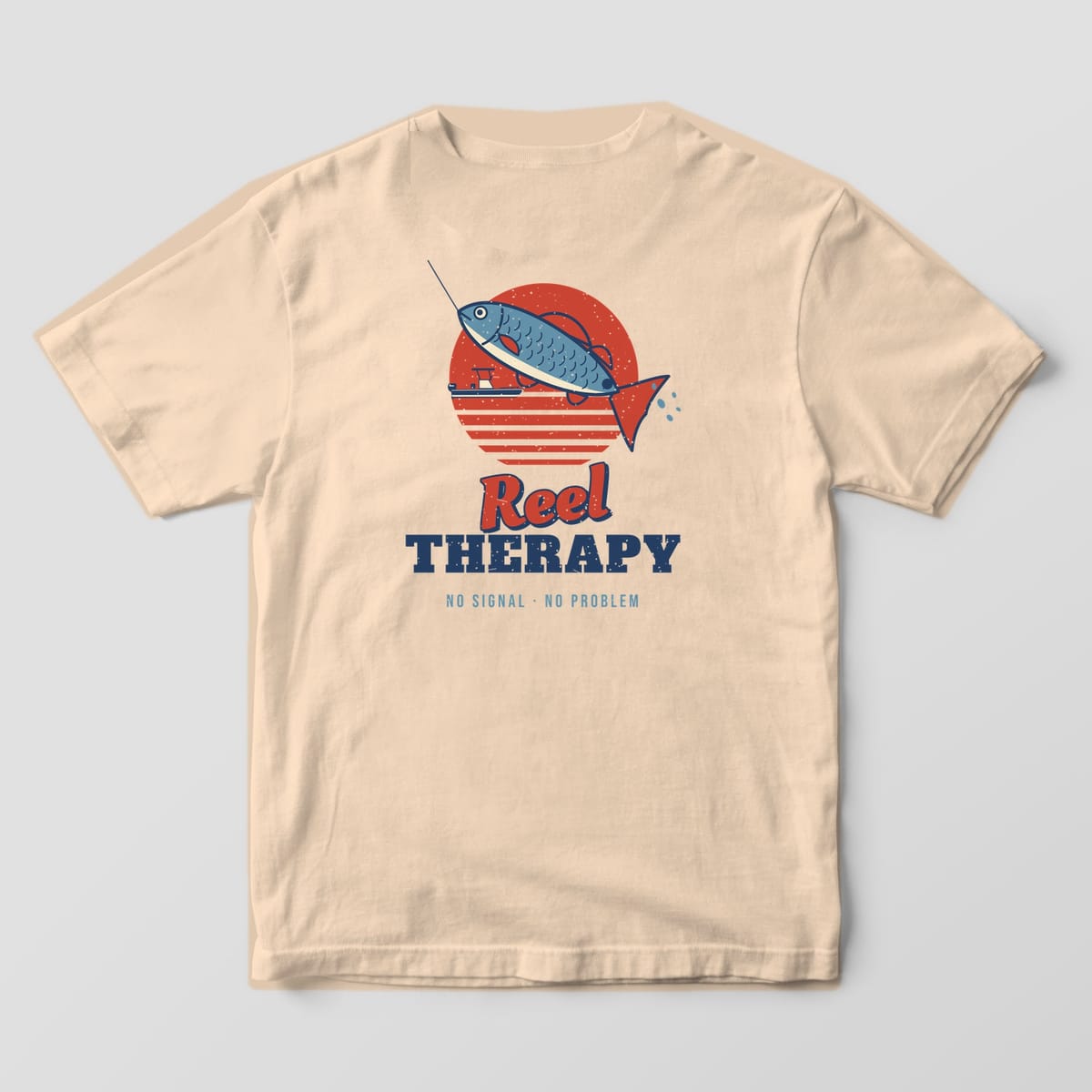Back of an ivory Comfort Colors 1717 T-shirt showing the retro sunset with a leaping fish on a fishing line, a small boat and the words Reel Therapy